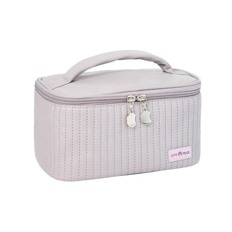 Open-top solid colour PU leather makeup bag in light blue on a white surface