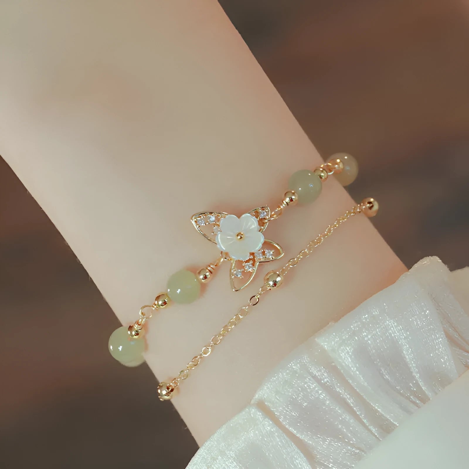 Women's yellow gold butterfly bracelet made from electroplated copper with a geometric shape.