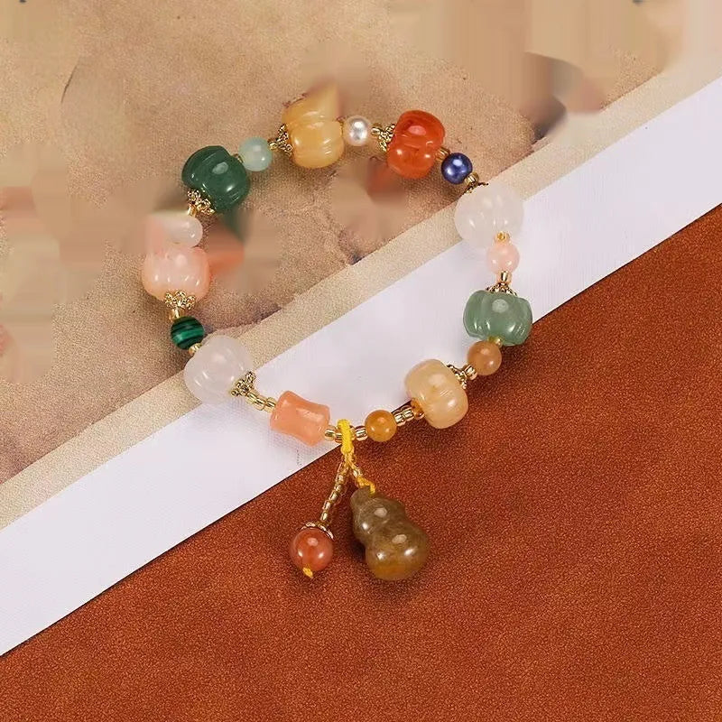 Carved Bodhi root bracelet with white jade, lotus, and pumpkin beads in various sizes.