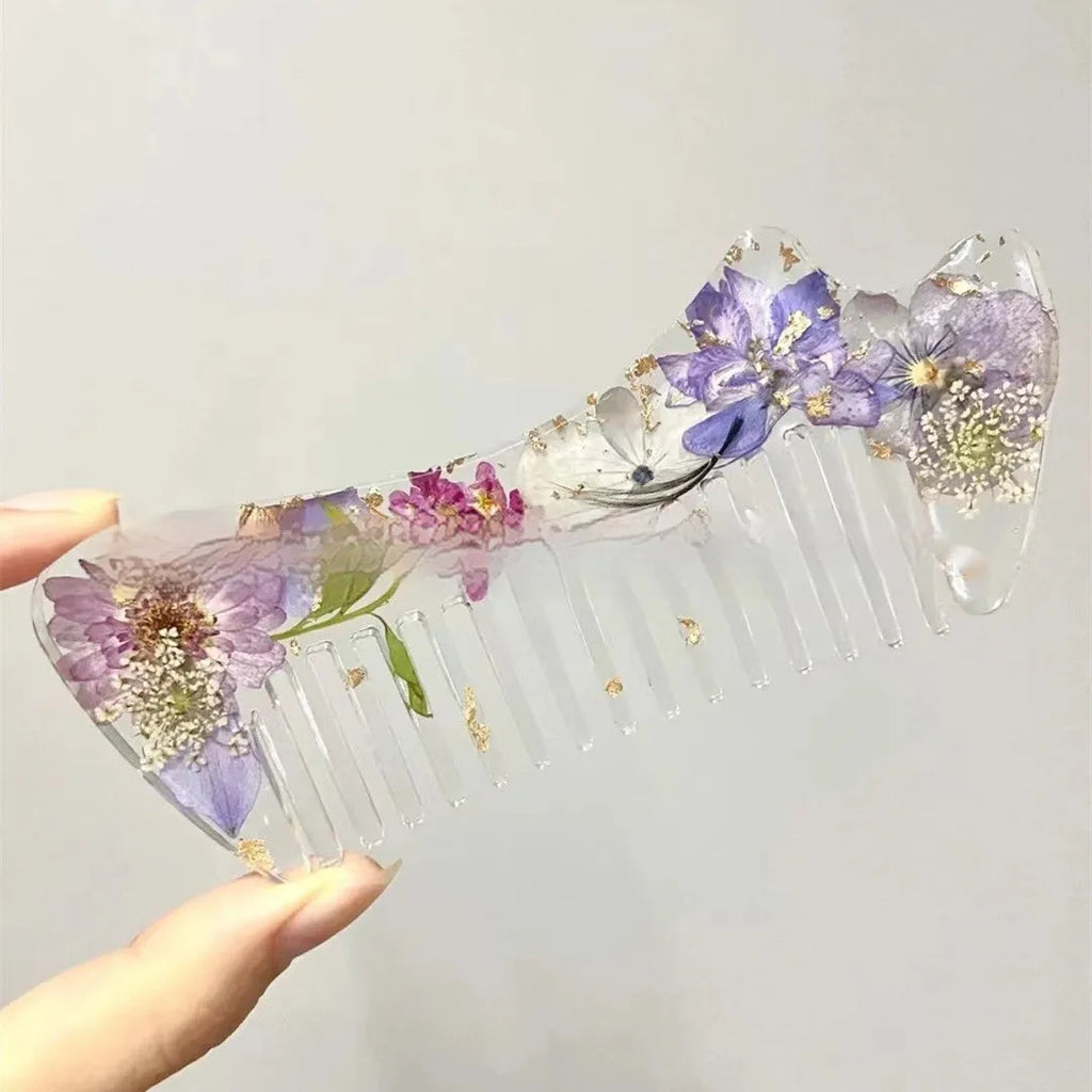 Small glossy resin hair comb with a reflective mirror finish, shown in one of three colour options.
