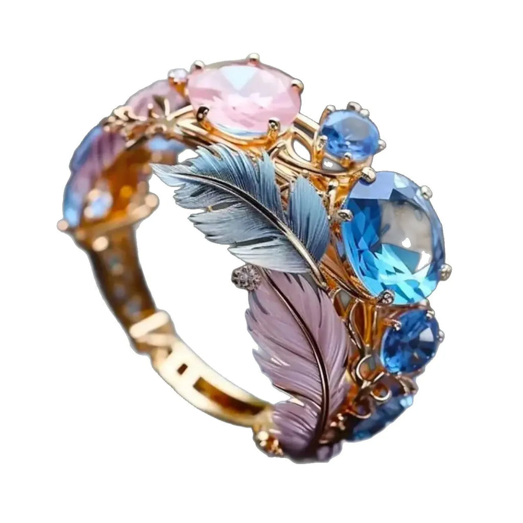 Geometric feather pattern brass ring with inlaid zircon stones in gold colour