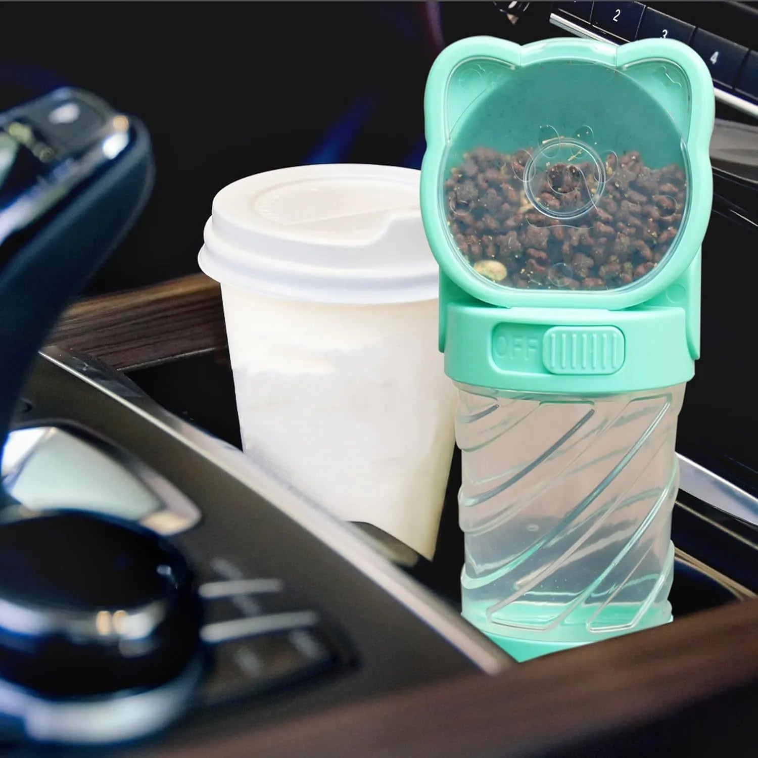 Green 3-in-1 portable pet water bottle with food container and waste bag dispenser on a strap.