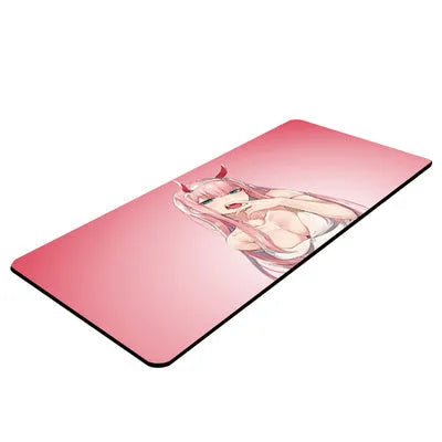 Pink cloth keyboard mat with Darling in the Franxx anime print on a desk