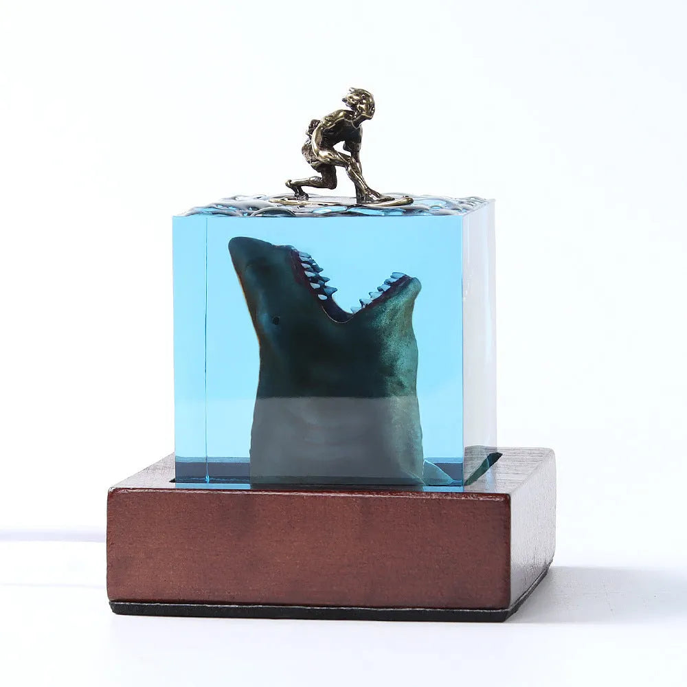 Epoxy resin shark surfer night light ornament on a desk with glowing micro landscape.