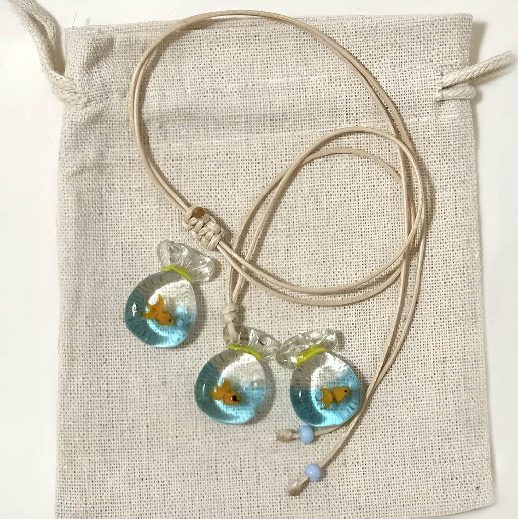 Women's necklace with a coloured glaze Small Fish Lucky Bag pendant on a cotton and linen clavicle chain.