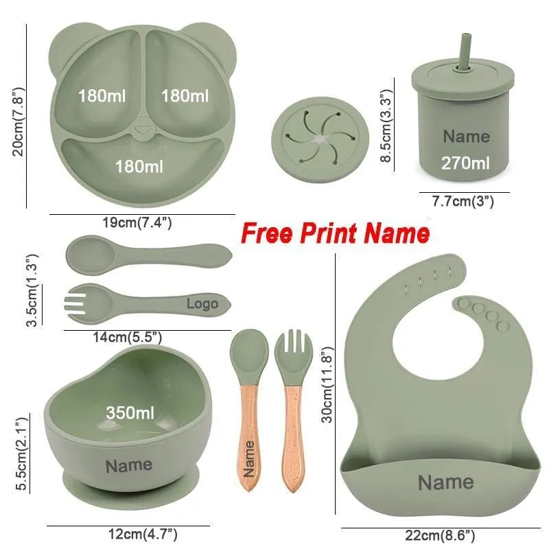 Children's silicone tableware set with cat ear cup in beige, blue and other colours on a table