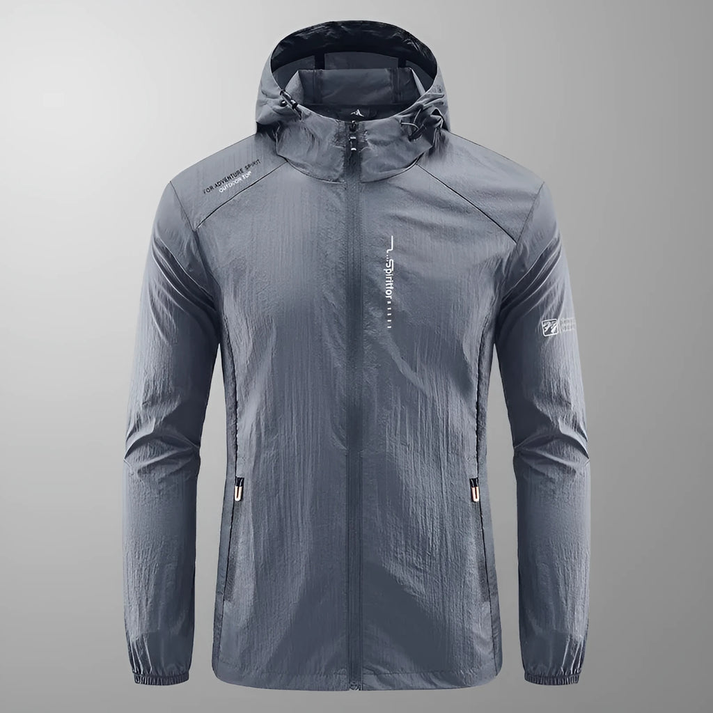 Man wearing a light grey loose-fitting hooded nylon summer jacket for sun protection.