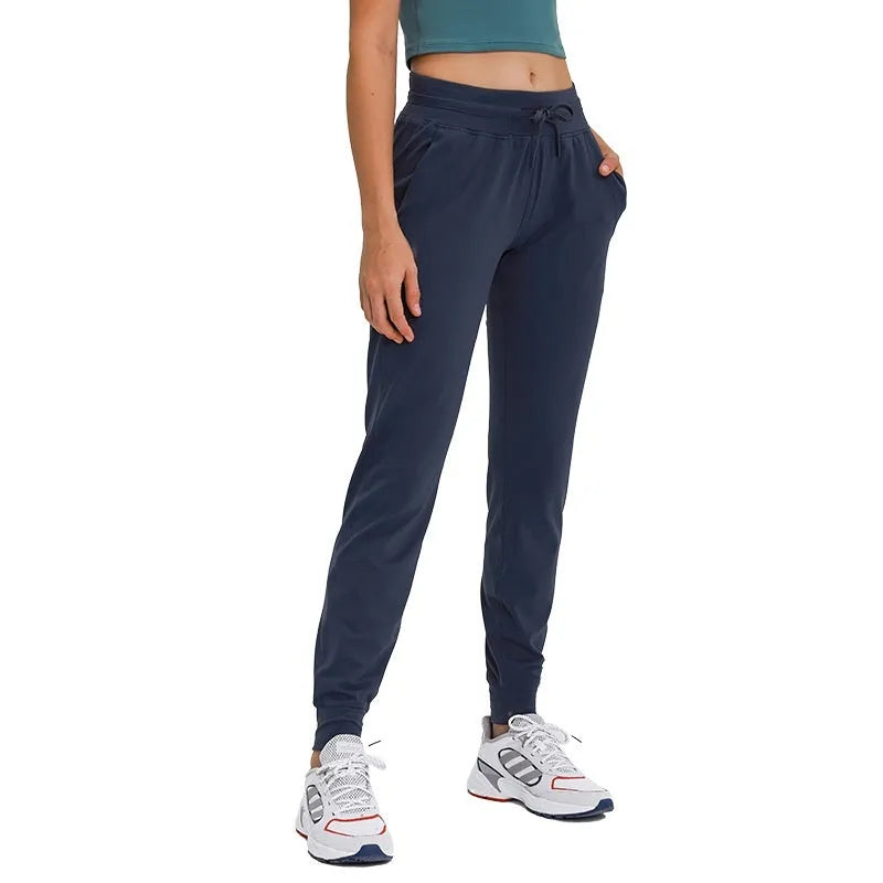 Women's high waist yoga pants in cotton blend fabric with drawstring waistband for running and fitness