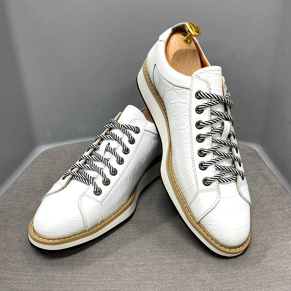 Low-top handmade men's shoes with an embossed pattern, shown in a choice of colours including black and green.