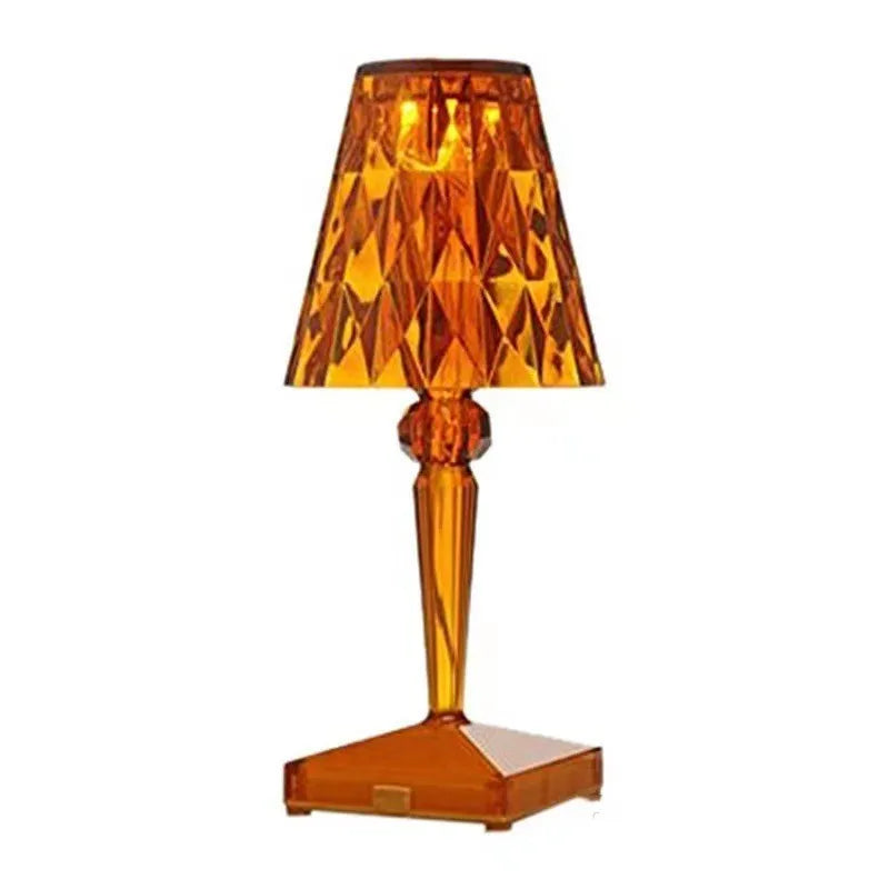 Rose gold portable touch control night light with dimming settings on a surface.