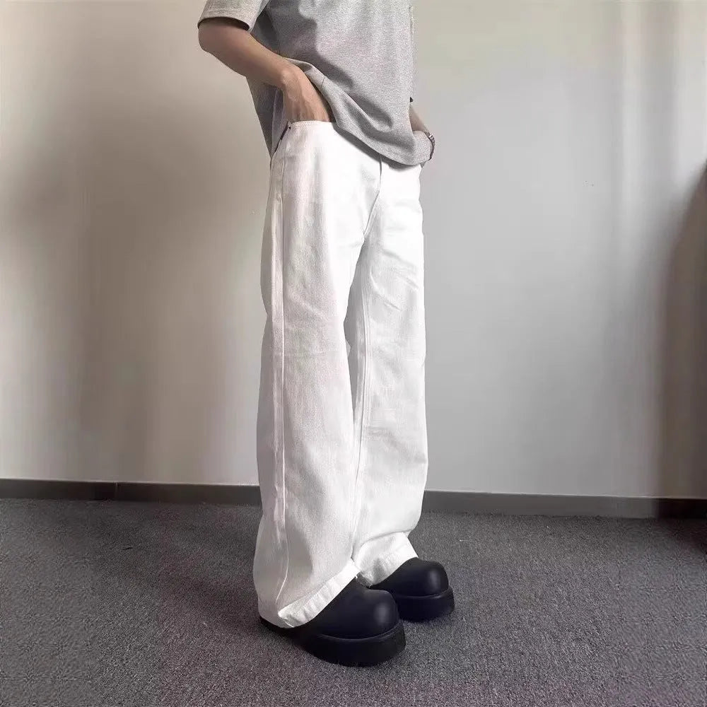 Men's white loose straight-leg jeans with wide leg openings and mid-waist design