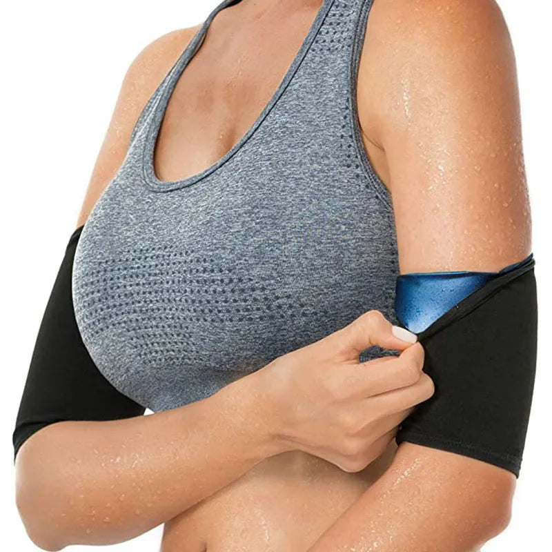 Blue compression arm band with a separate black wrist support strap laid flat.