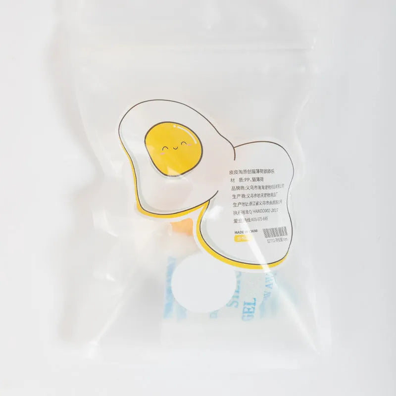Soft plush catnip ball toy in egg shapes stuck to a wall for interactive cat play.