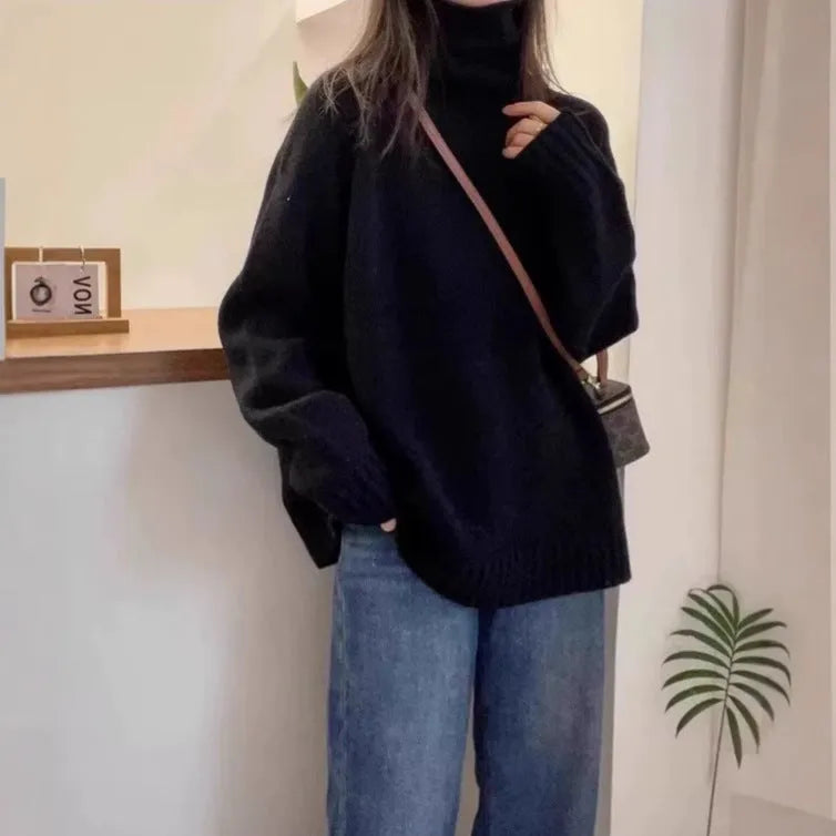 Women's thick loose turtleneck sweater in black with curling pile collar and 3D pattern