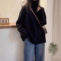 Women's thick loose turtleneck sweater in black with curling pile collar and 3D pattern