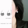 Drop-shaped geometric golden beans and diamond ear clip earrings in gold and white colours.