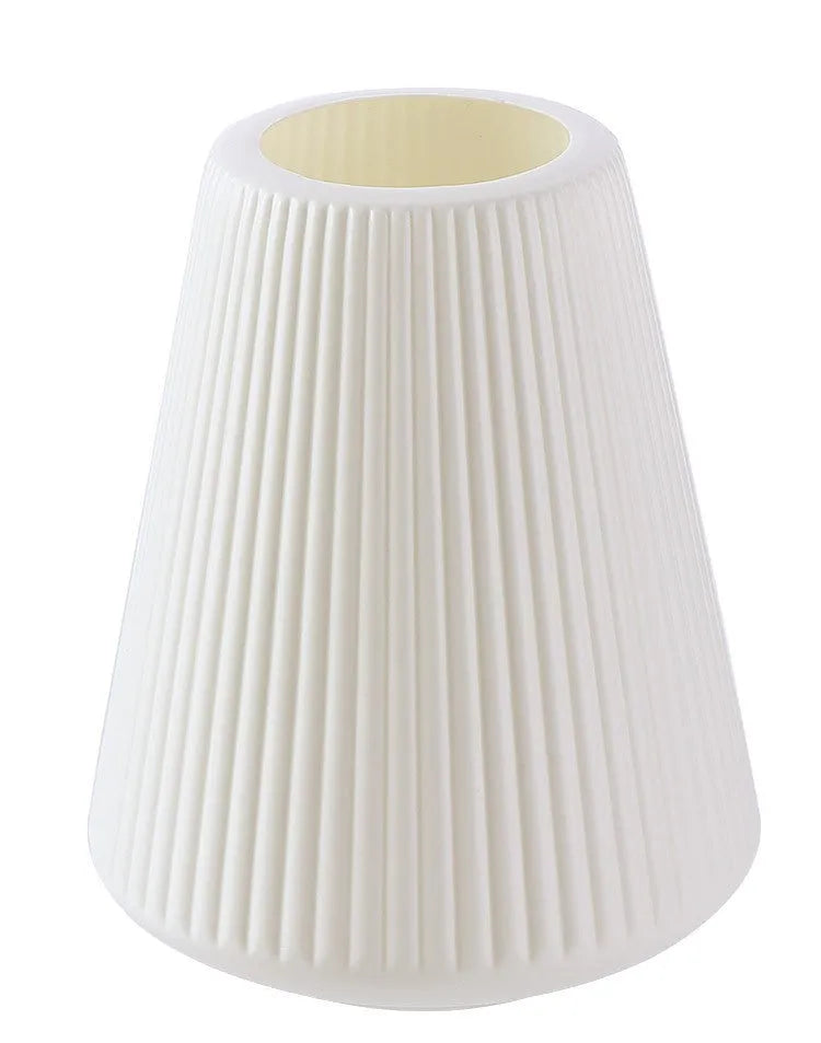 Blue melamine plastic decorative flower vase on a wooden desktop.