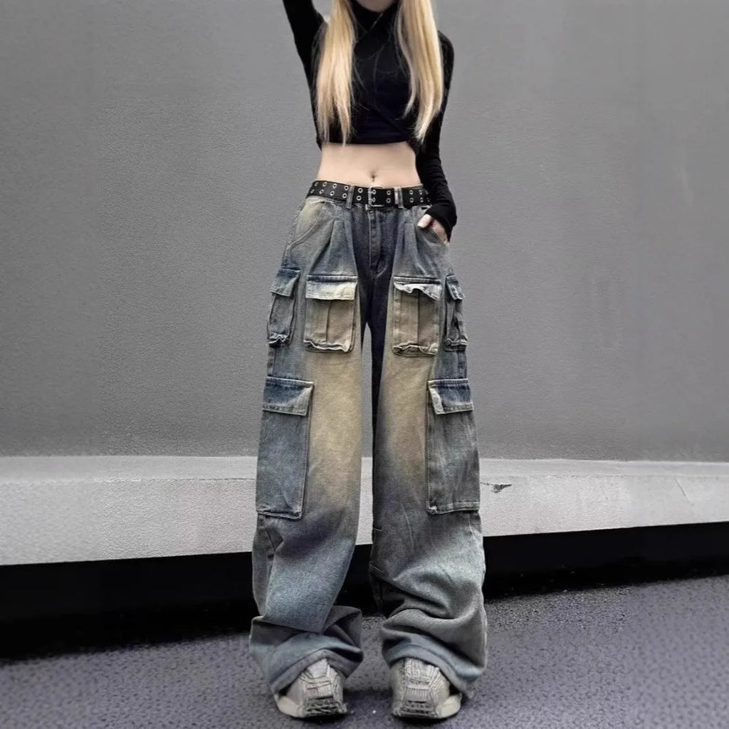 Loose fit light blue denim jeans with multiple pockets and a distressed washed finish on a neutral background.