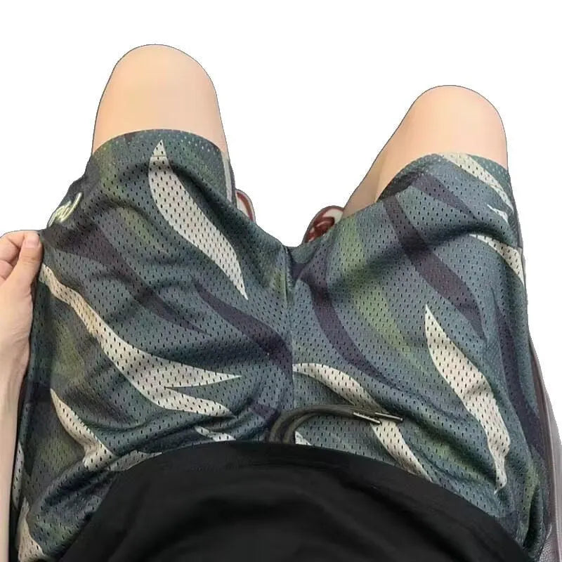 Men's camouflage pattern mesh shorts in straight-leg cut on mannequin