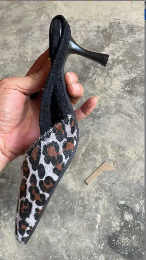 Leopard print women's suede sandals with a pointed toe, shown from the side.