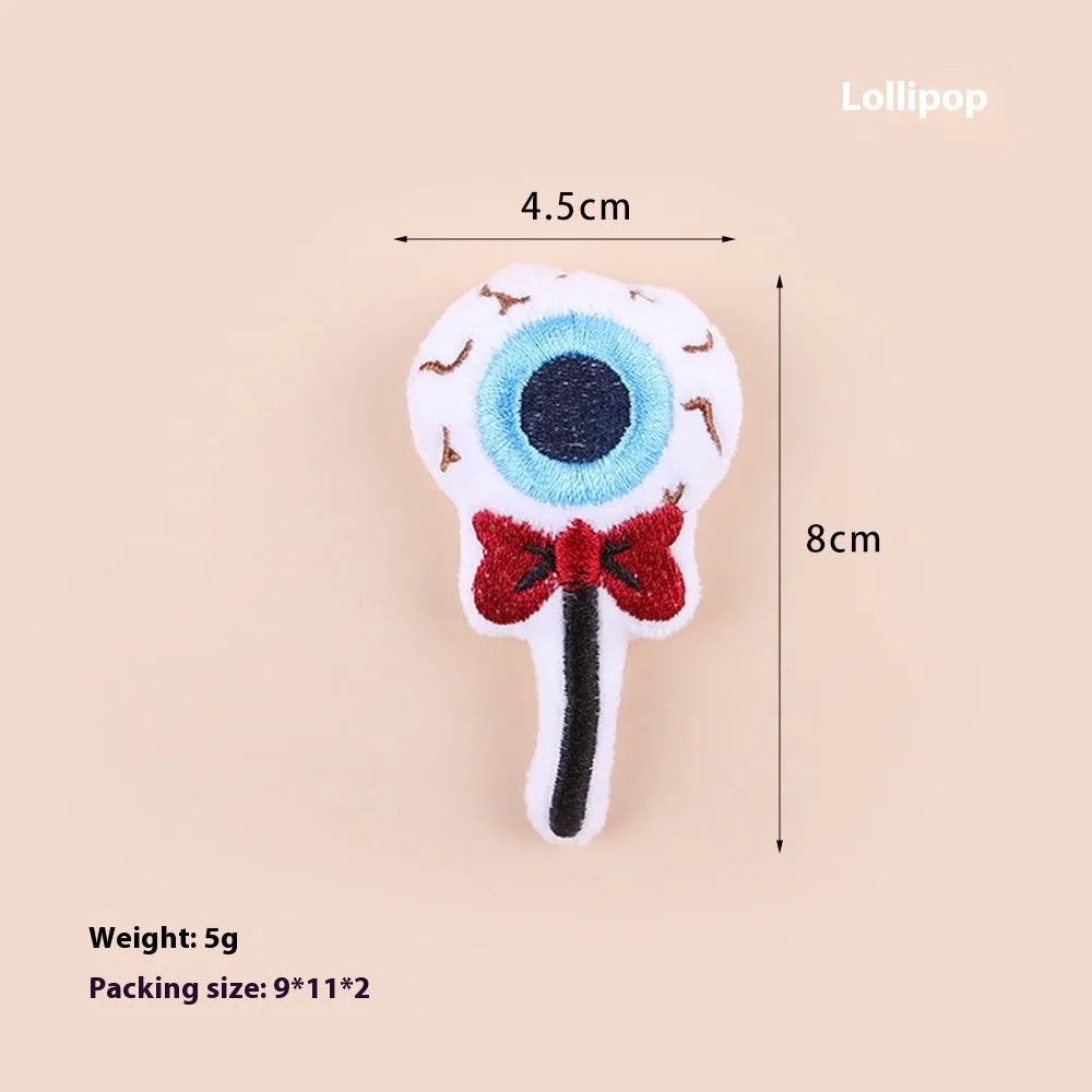 Small cat teaser wand with dangling plush candy, eye, and skull toy attachments