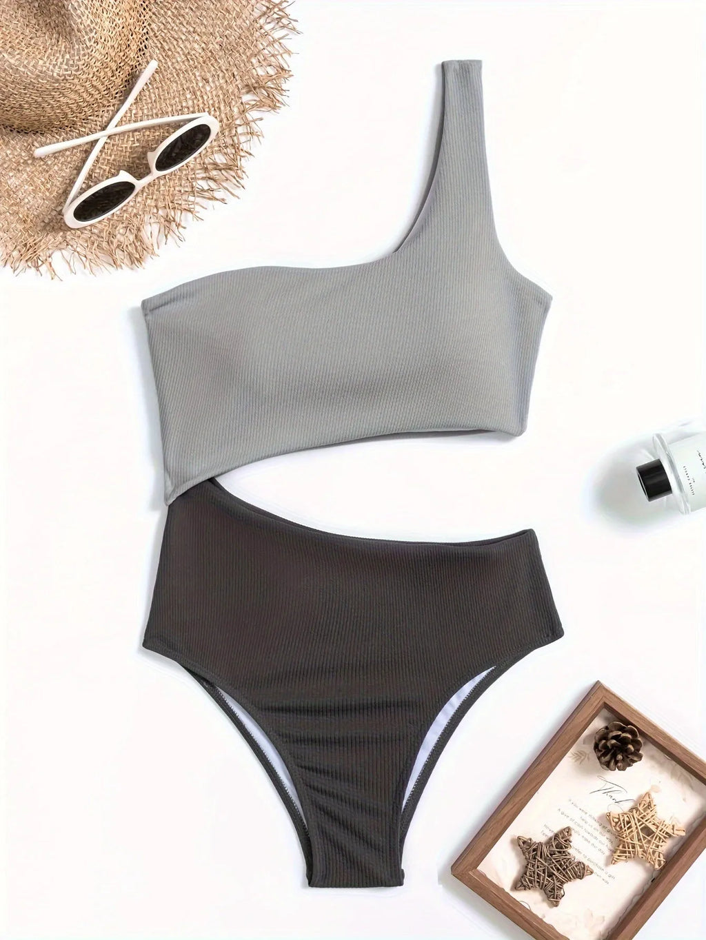 Light grey one-shoulder one-piece swimsuit on a model