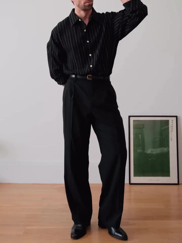 Black and white pinstriped men's long sleeve button-down shirt on a hanger.