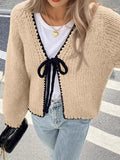Gray lace-up front cardigan sweater with white crochet flower details and loose long sleeves.