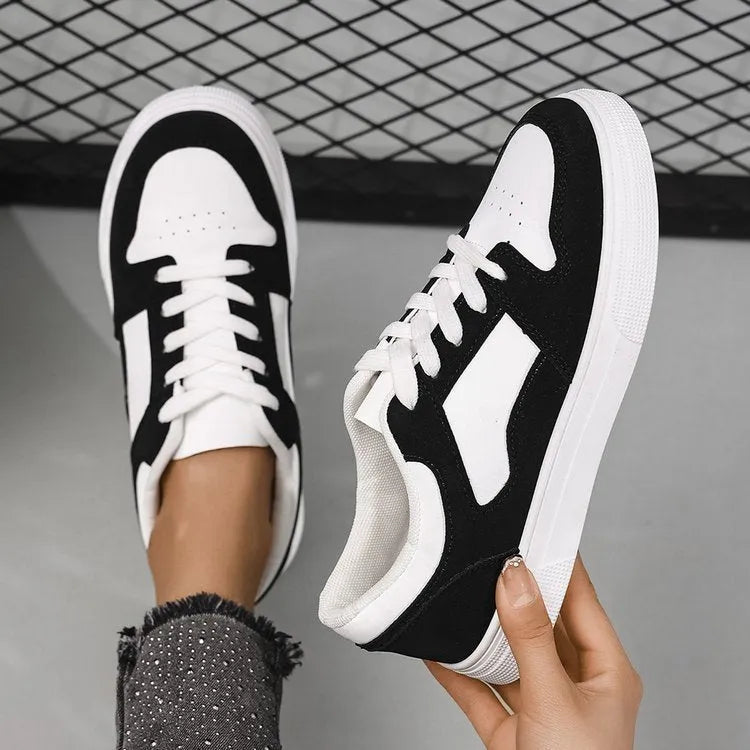 Black women's lace-up casual trainers with a round toe, low top, and rubber sole.