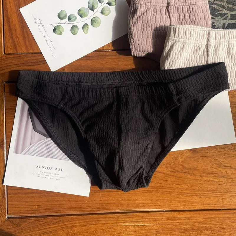 Men's solid colour cotton triangle briefs in apricot, shown from the front on a mid-waist fit model.