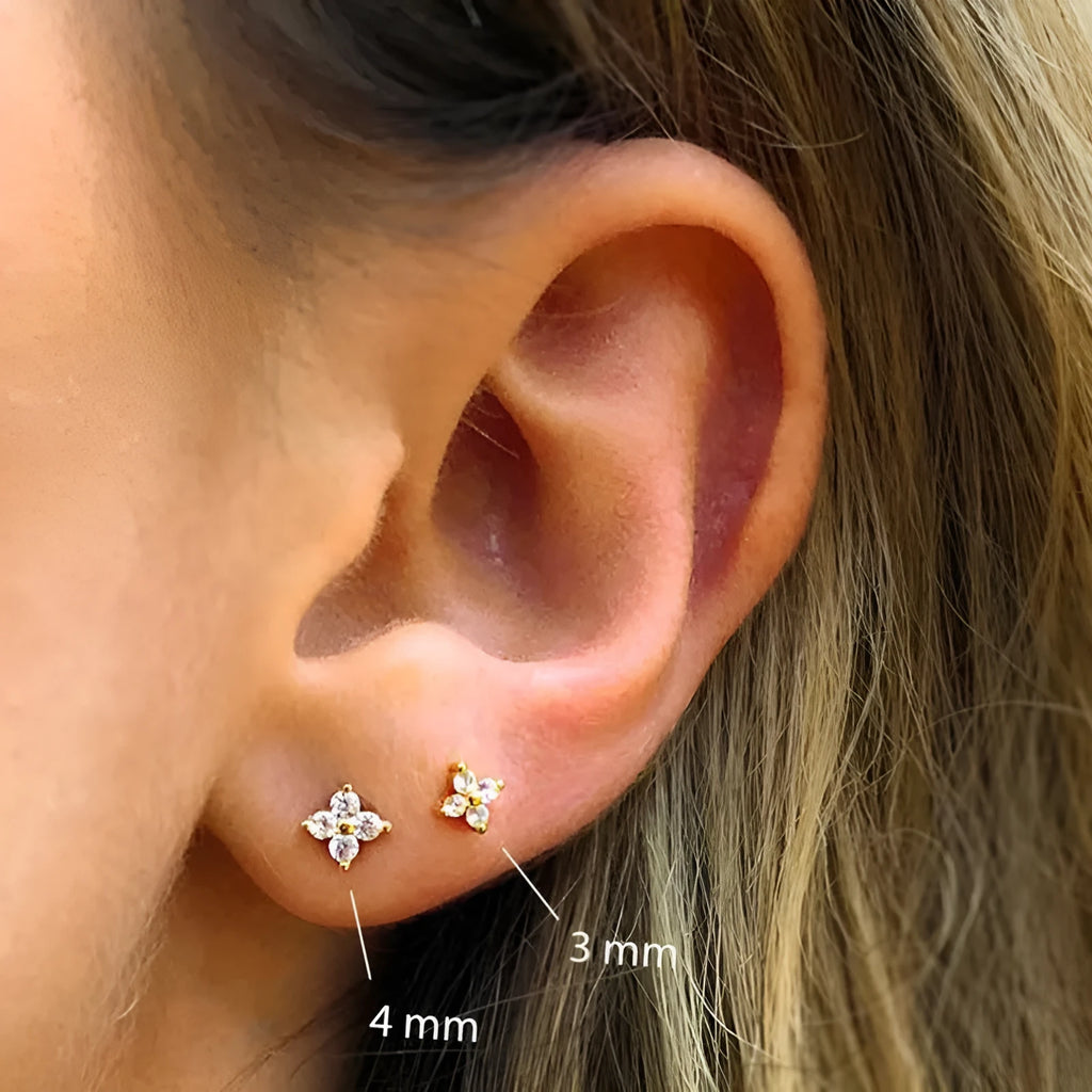 S925 sterling silver stud earrings with small petal crystal flowers in gold and platinum finishes.