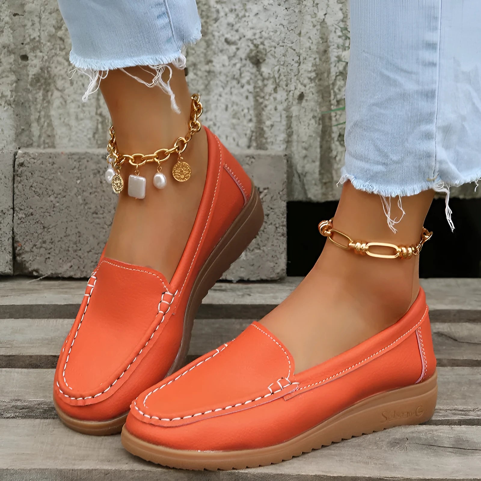 Women's flat slip-on loafers in PU leather with car suture detail, shown in multiple colours.