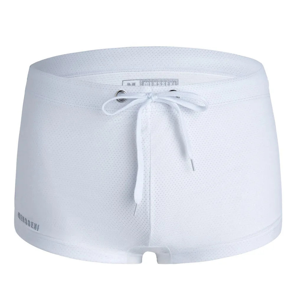 Men's low waist nylon swimming trunks in a solid colour on a white background.