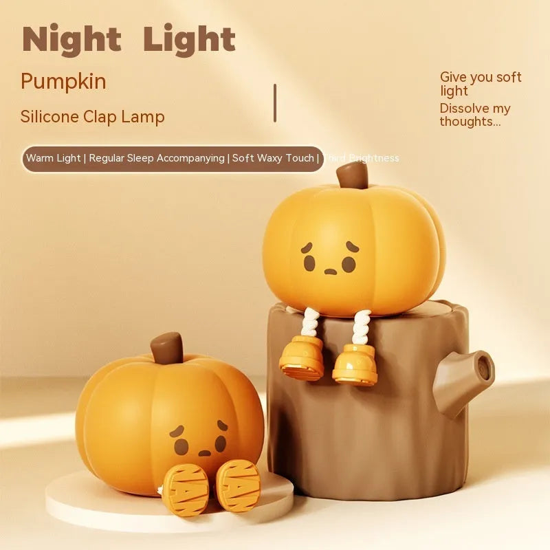 Pumpkin-shaped small night lamp in orange silicone with racket style design on table