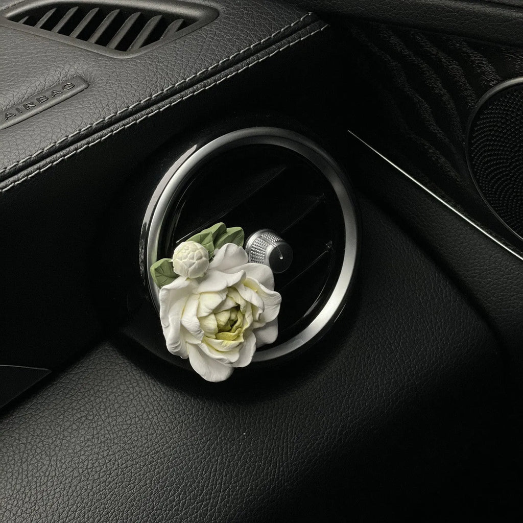 Solid gypsum car air freshener diffuser in air vent with jasmine fragrance oil.