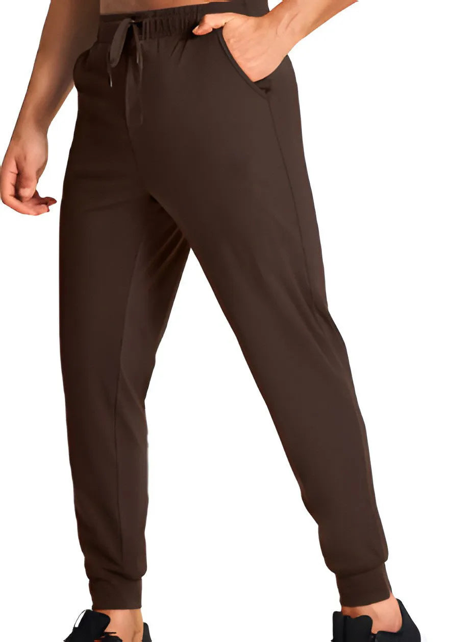 Men's solid colour loose casual trousers in polyester fabric on a hanger.