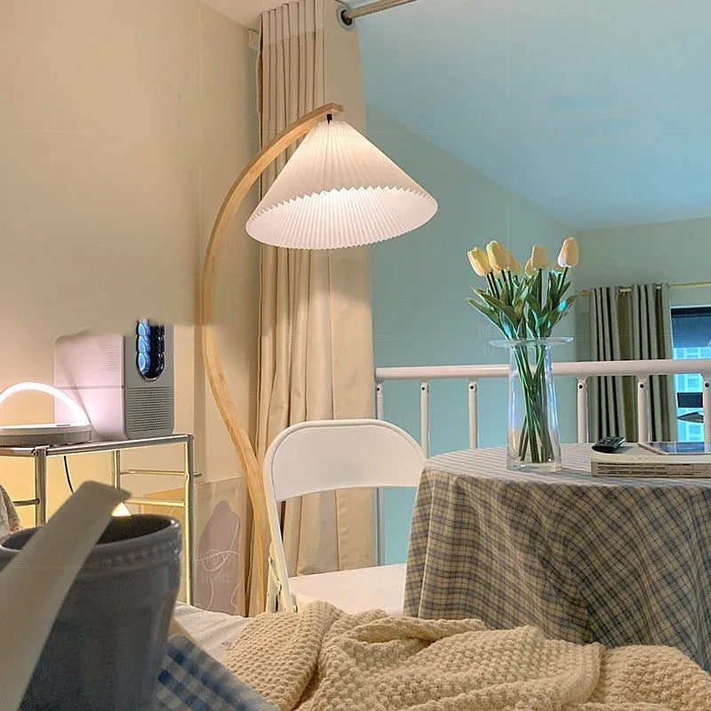 Vertical retro floor lamp with wood shade in three-colour variable light beside bed