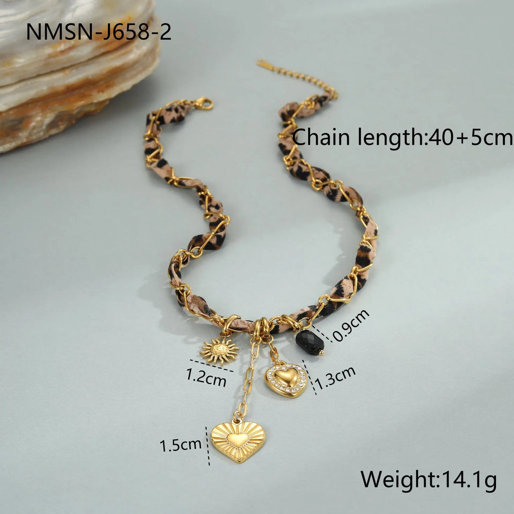 Leopard Love stainless steel necklace with 18K gold plating, showing geometric Big Heart or Love Sun pendant on an adjustable chain.