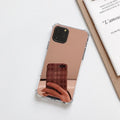 Silver mirror finish hard PC phone case for Apple iPhone on a table.