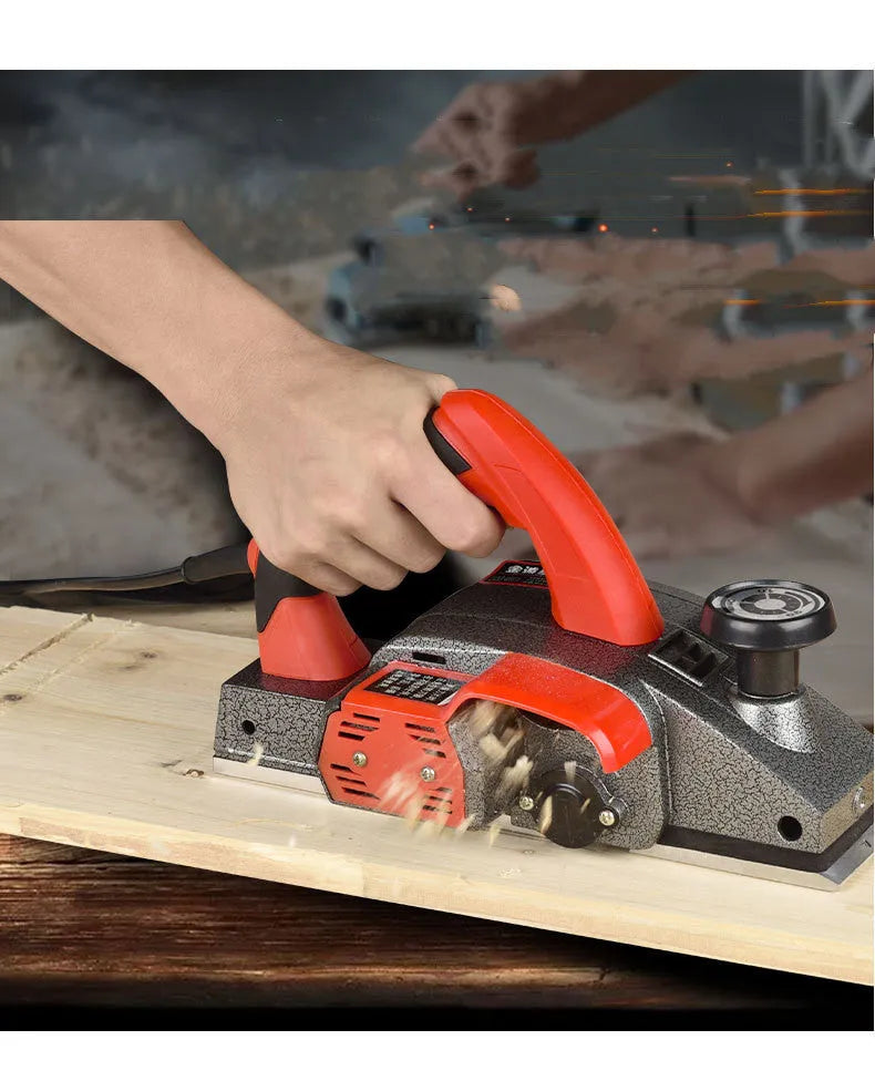 Red desktop electric wood planer with aluminium housing showing 82mm planing width