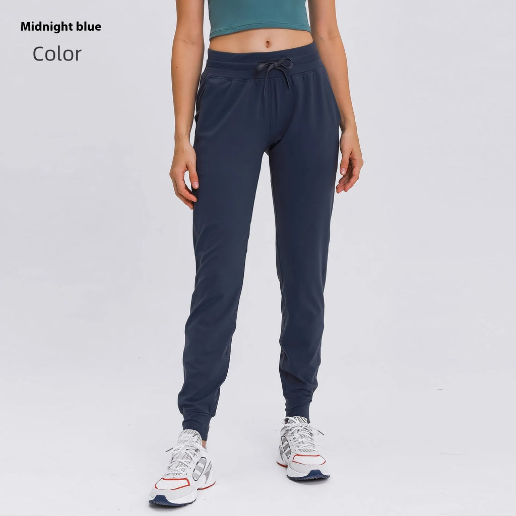 Women's high waist yoga pants in cotton blend fabric with drawstring waistband for running and fitness