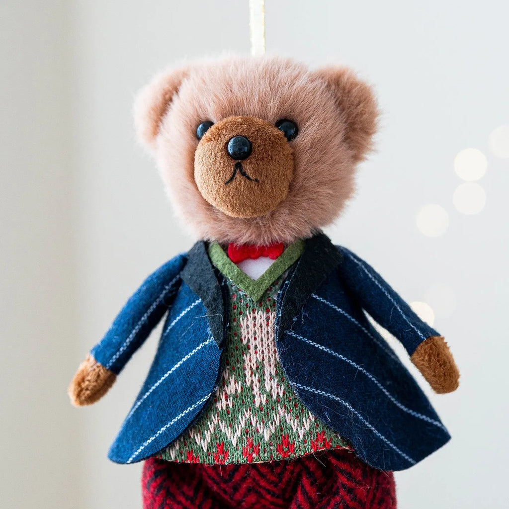 Pair of plush bear dolls wearing red and black plaid cotton clothing, cartoon style.
