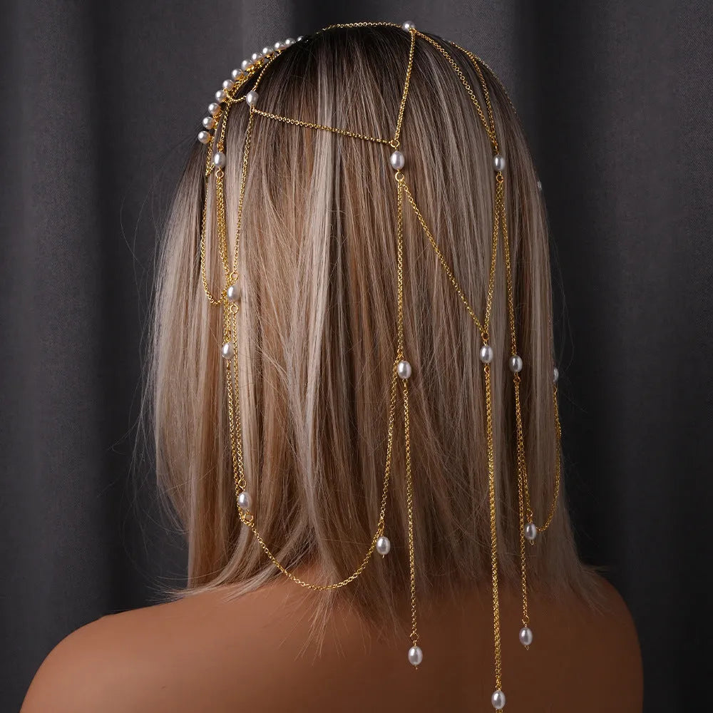 Women's gold mesh hair chain with tassel and pearl decorative elements.