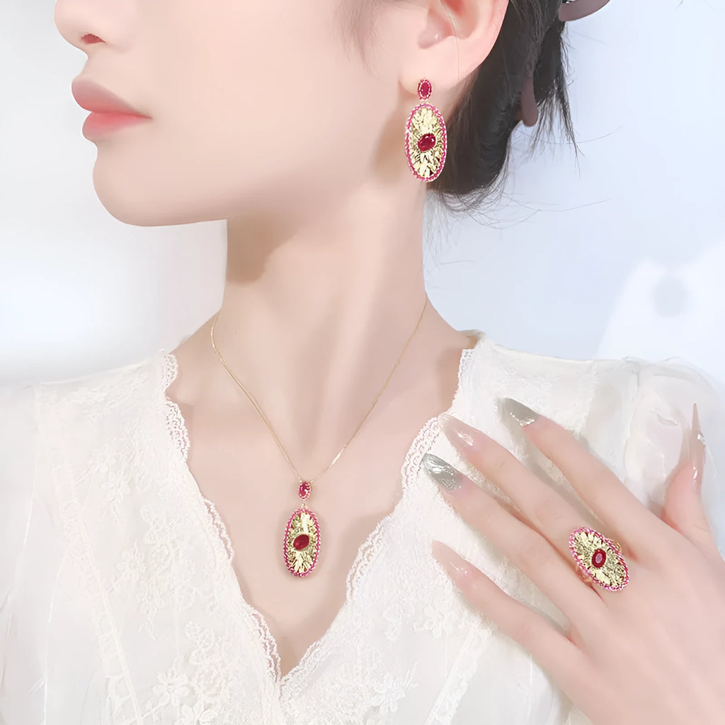 Gold-plated red corundum jewellery set showing necklace, ring and ear studs with diamond-cut water drop design