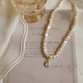 Vintage pearl necklace with geometric pendant on adjustable chain