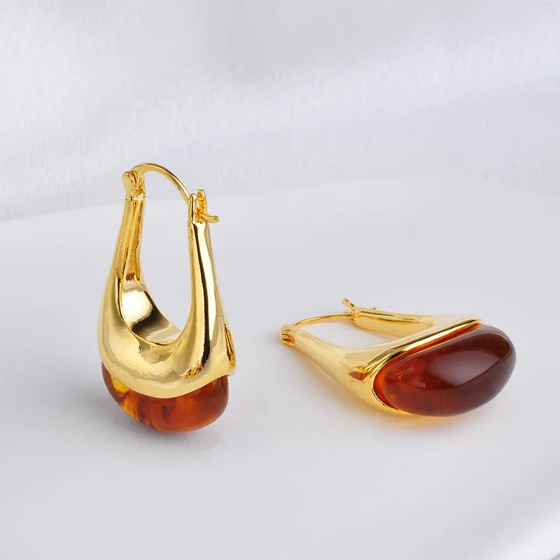 Copper geometry shape retro Maillard style earrings with electroplated finish in amber colour option on plain background