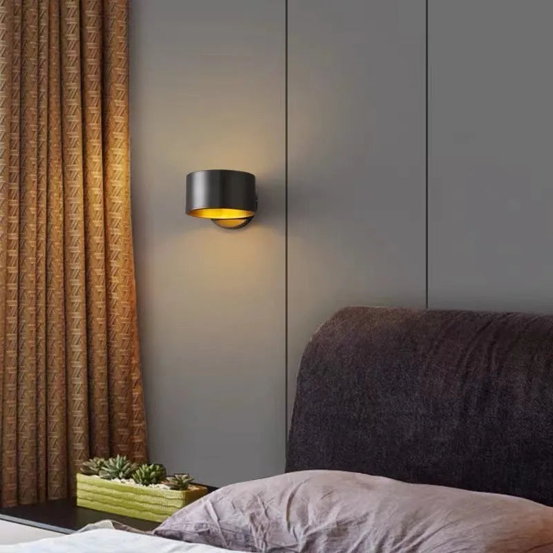 Modern copper wall light fixture in gold finish mounted on a wall