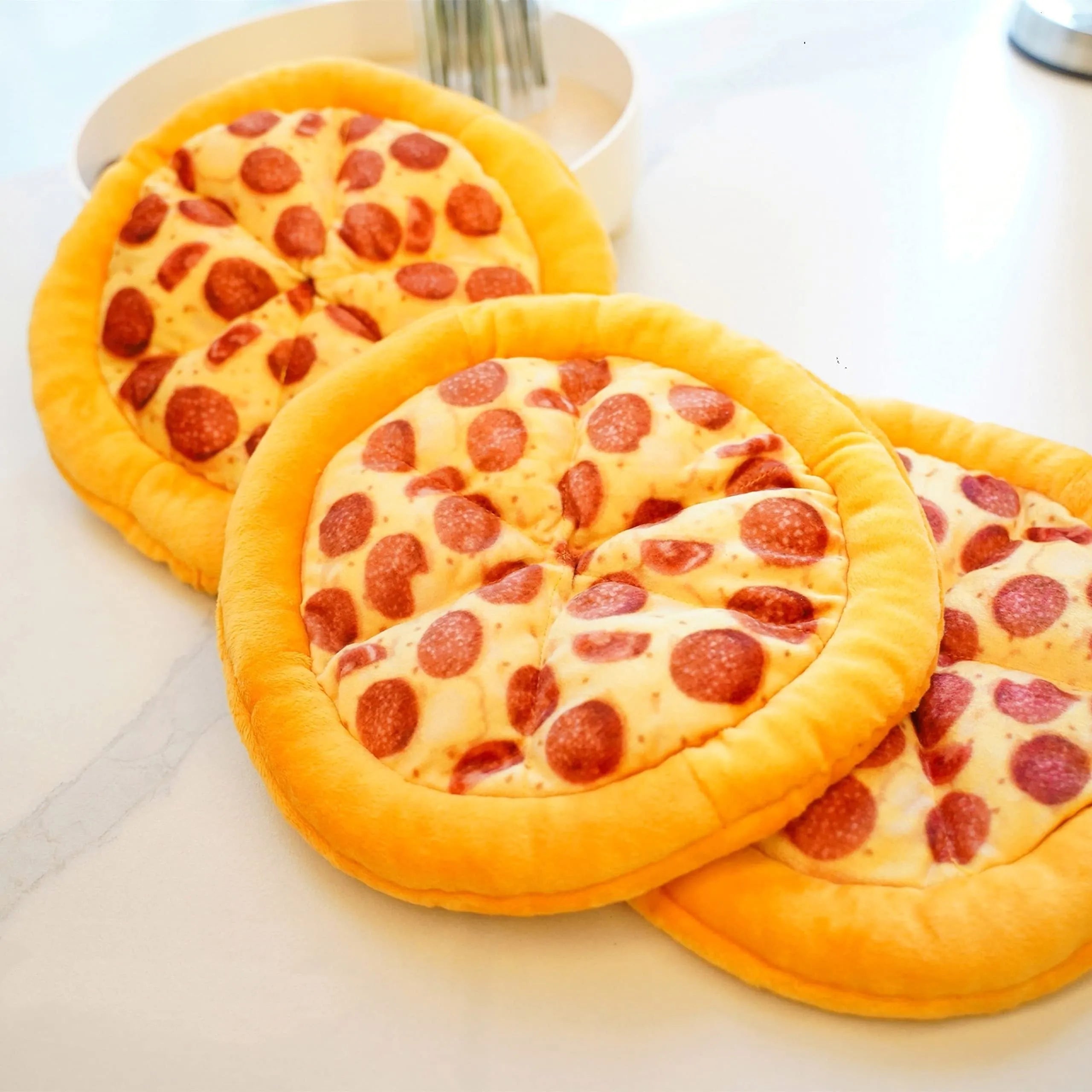Yellow teddy bear dog chew toy holding a pizza slice with a squeaker inside.