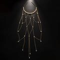 Women's gold mesh hair chain with tassel and pearl decorative elements.