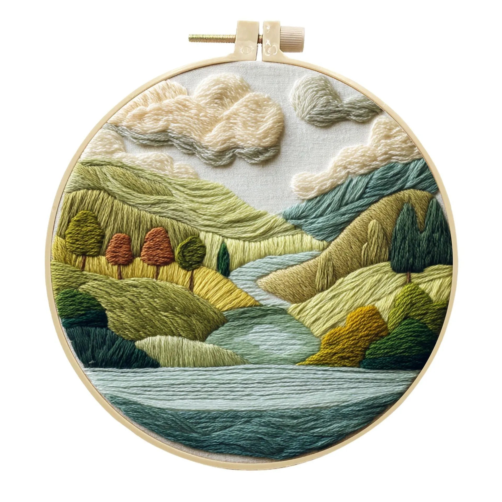 Embroidery DIY kit with bamboo frame, cotton fabric printed with a landscape scene, threads, and needles laid out